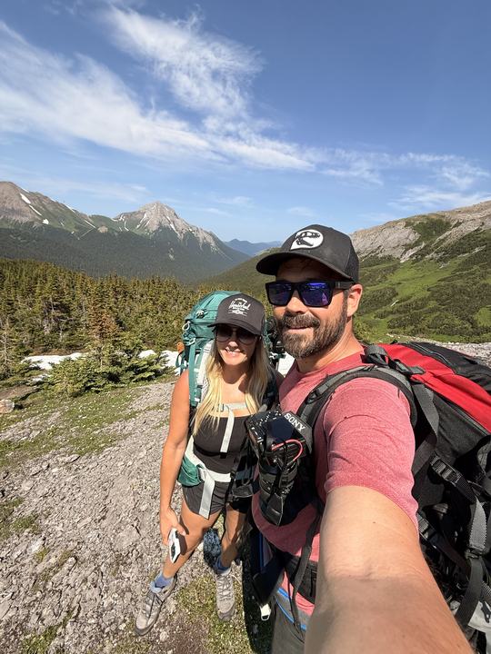 Stacie and Ryan with full packs on the Circular Route, peaks behind