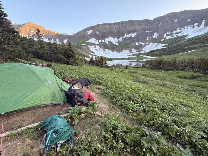 The tent and backpacks in the meadow below the Windfall Lake headwall