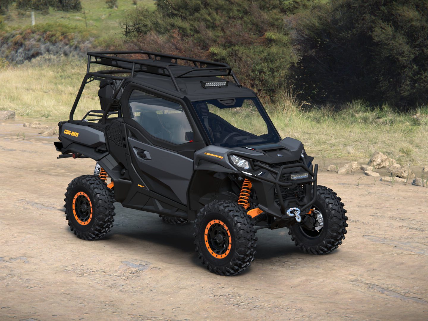 The built Can-Am Commander XT-P from the front three-quarter, showing the roof light bar, glass windshield, headlight guards, and winch