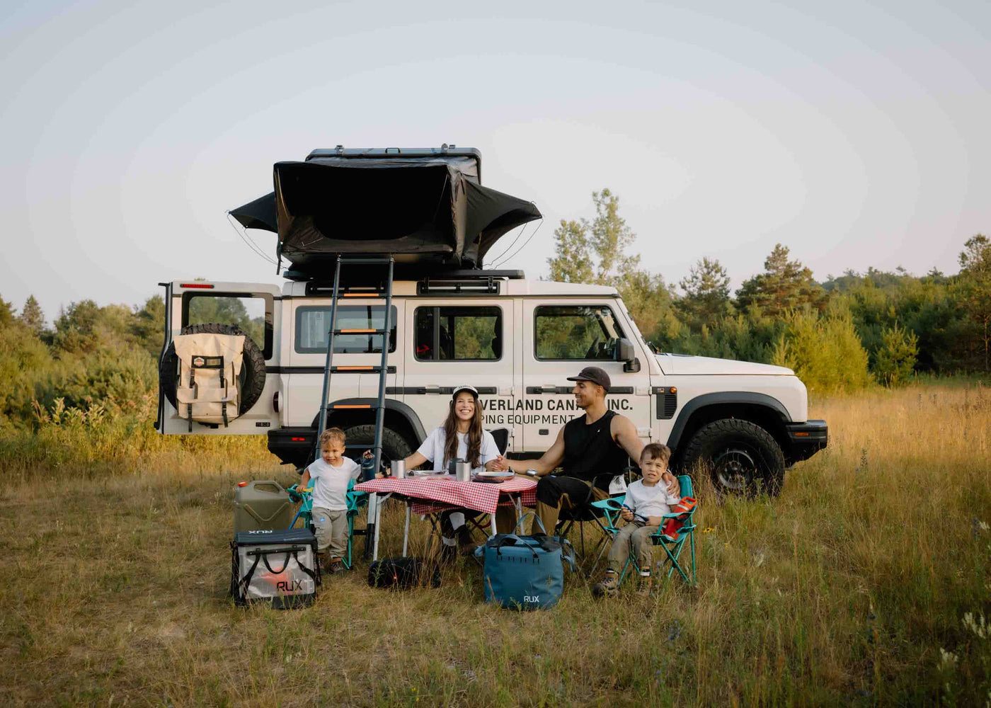 A family at camp beside an Expedition Mini