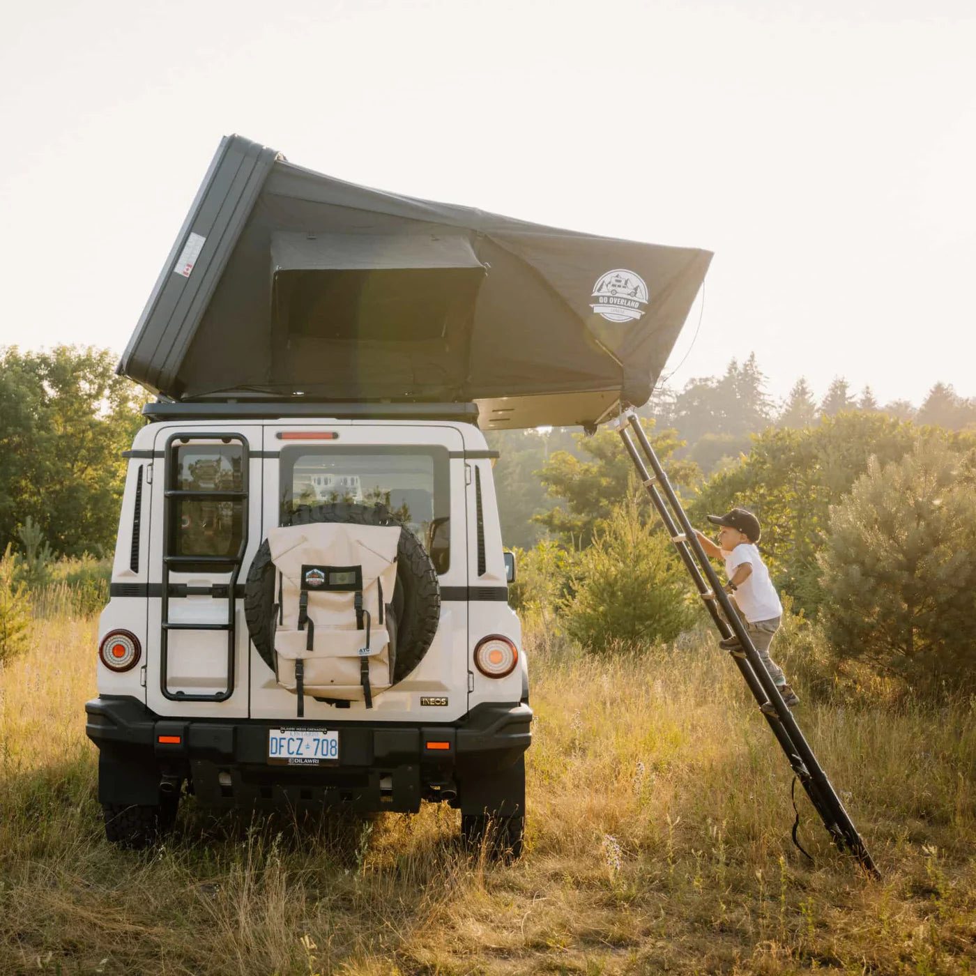 Expedition L rooftop tent open on an SUV in a field