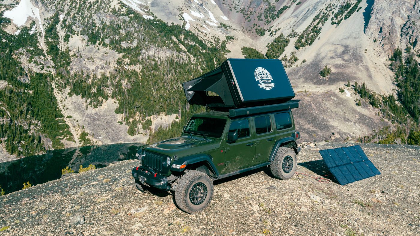 Expedition Max rooftop tent on a green Jeep on a mountain ridge