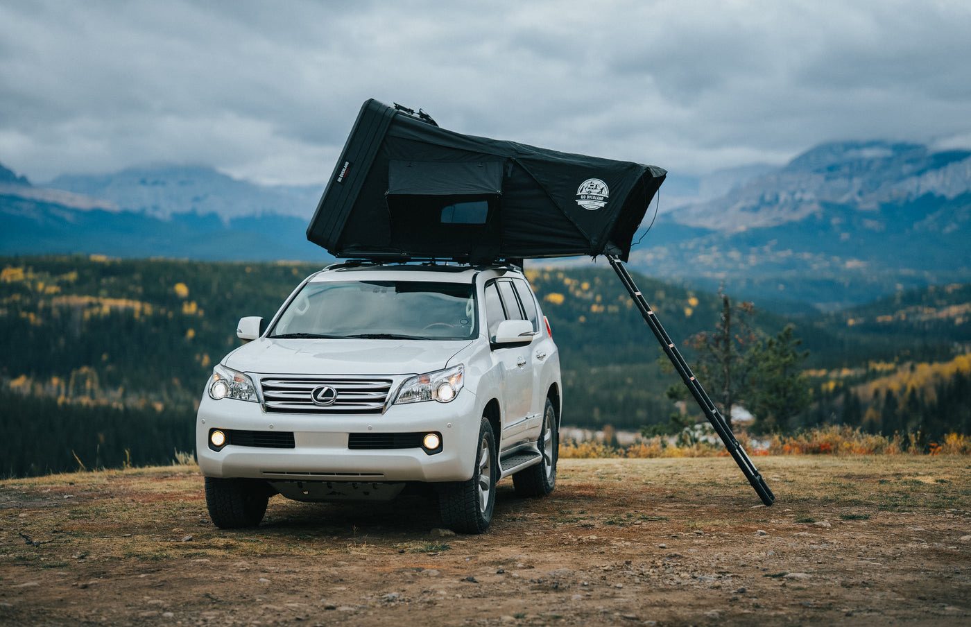Expedition Mini rooftop tent open on an SUV above a valley