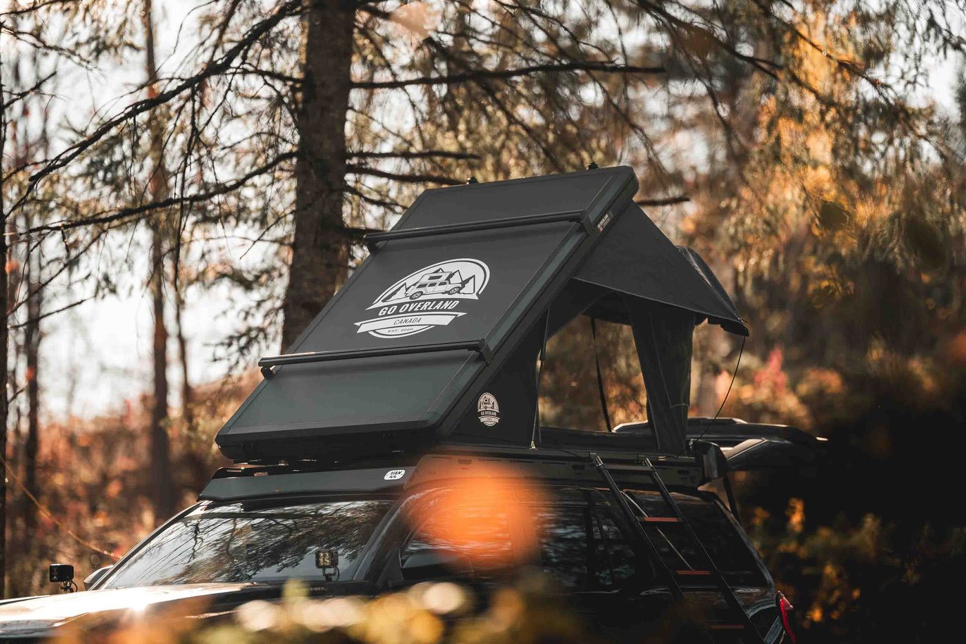 Summit Lite rooftop tent open in an autumn forest