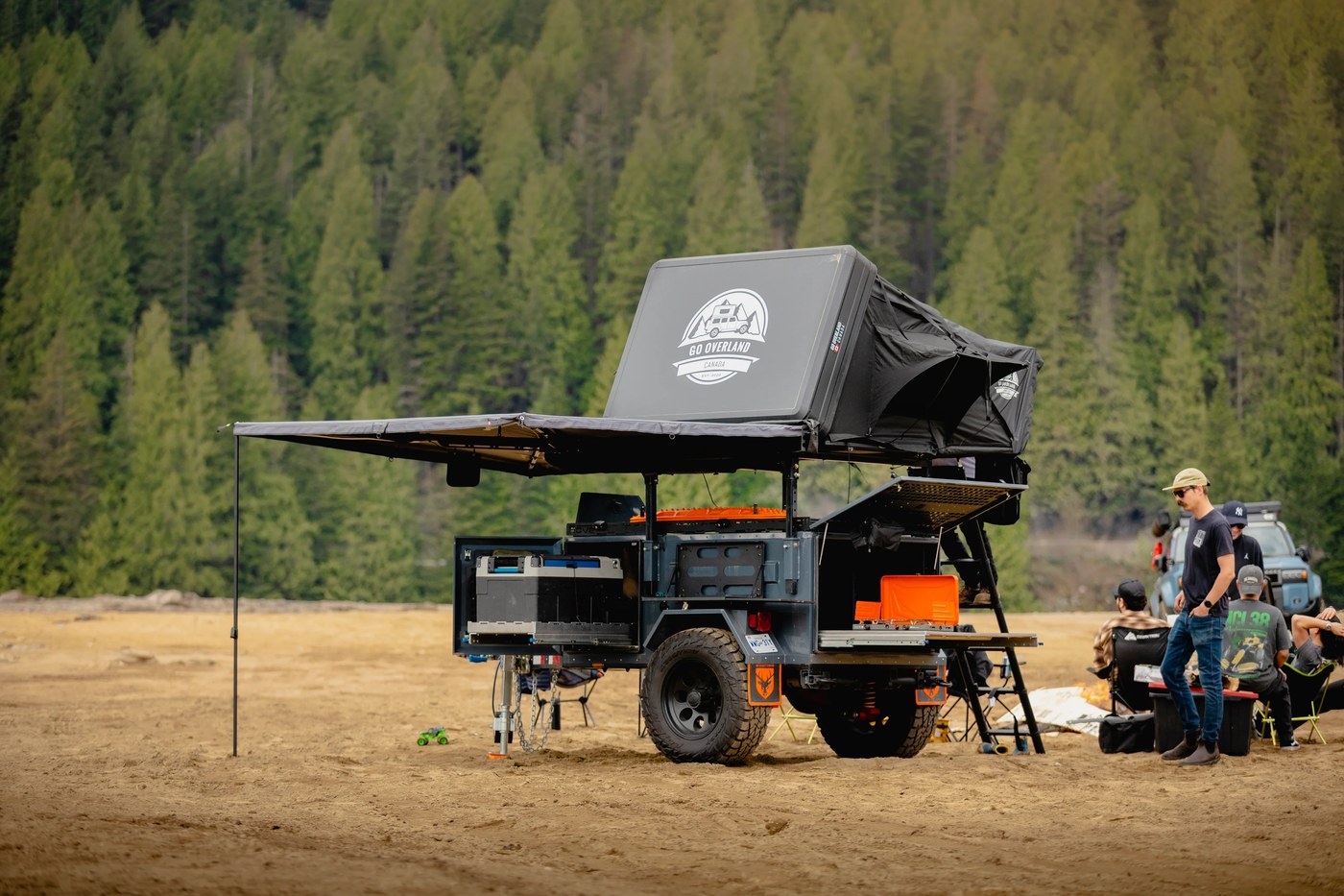 A Rove Recon trailer set up at camp with its rooftop tent deployed