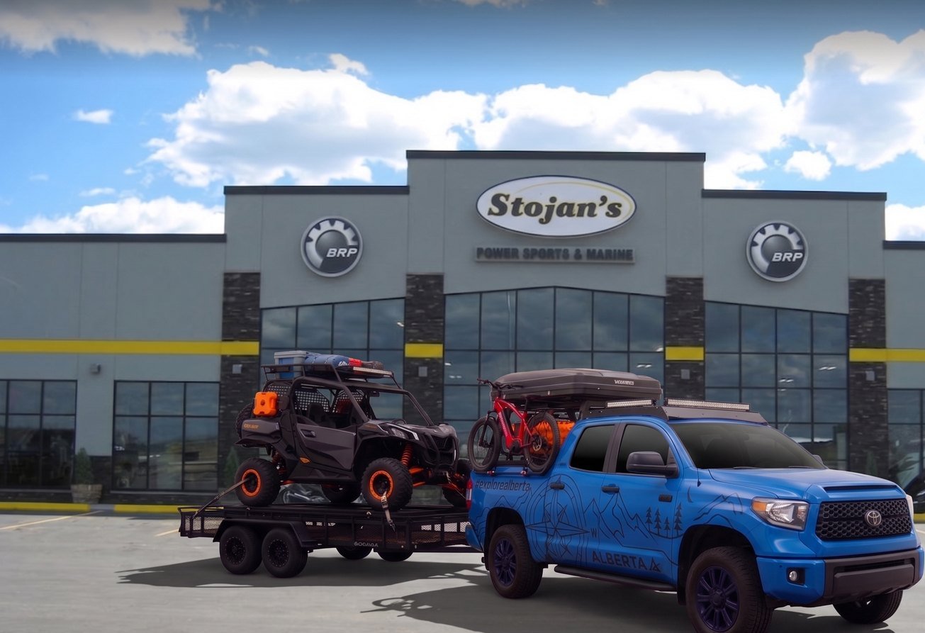 The Alberta-wrapped Tundra and the Commander on the trailer outside the Stojan's Power Sports and Marine showroom